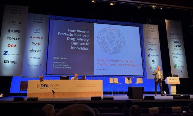 Photo of Prof David Morton (Deakin University) on stage presenting at the DDL 2025 conference